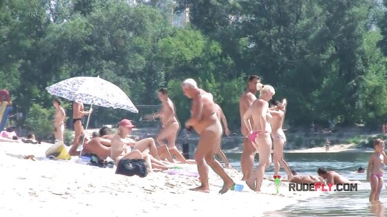 Curvaceous nudist teens strolls around  on the beach and enjoys a sunny day